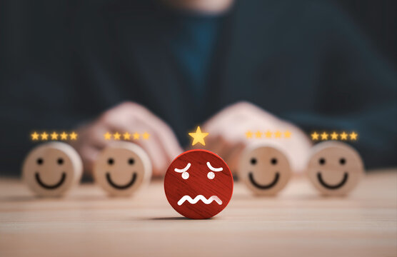 Customer satisfaction and feedback evaluation concept with unhappy face icon among happy ratings review. Business service quality assessment, client experience analysis and reputation management.