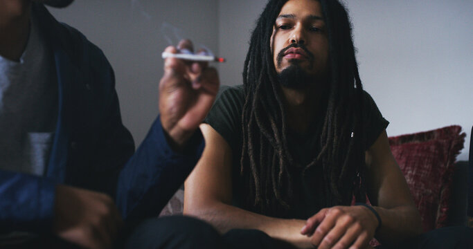 Man, thinking or smoking weed with friends in home for stress relief, trippy or cannabis joint on 420. Euphoria, people and THC blunt at hangout on weekend to relax, social consumption and reflection