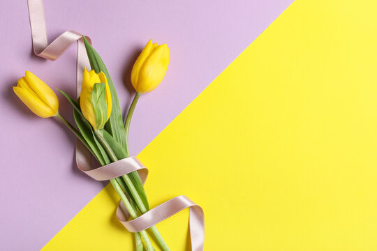 Beautiful bouquet of tulip flowers on color background