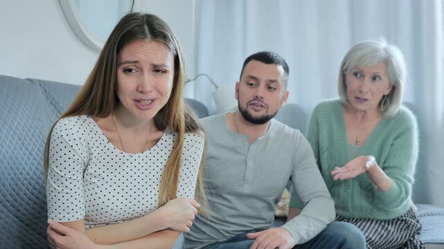 Upset woman dont speaking after discord with mother and husband standing behind. High quality 4k footage
