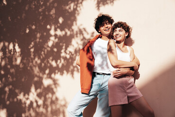 Young smiling beautiful woman and her handsome boyfriend in casual summer clothes. Happy cheerful...