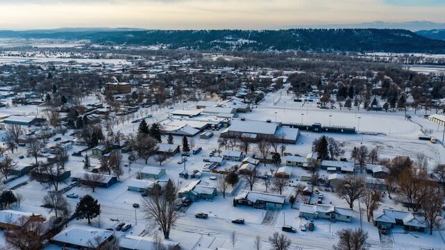 Aerial hyperlapse over the snow covered small town of Columbus, Montana in winter