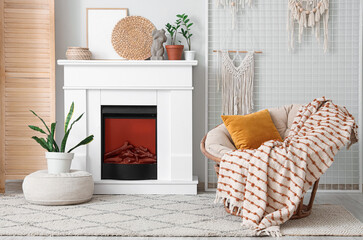 Naklejka premium Interior of cozy living room with fireplace, armchair and pin board