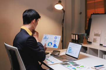 Man analyzing business data reports and financial charts