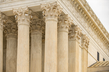 Columns marble Tall vertical facade. Columns architectural symmetry texture. Columns decorative capitals ornament Sculpture. Columns classical structure. © Svitlana