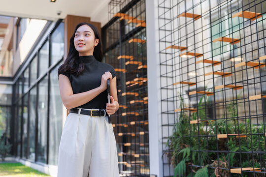Young asian business woman looking forward with tablet