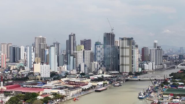 Manila cityscape with the pasig river under overcast sky