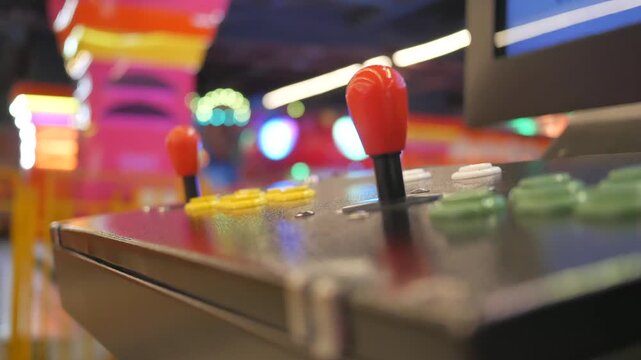 Retro arcade game machine control panel with red joysticks and colorful buttons in neon gaming hall