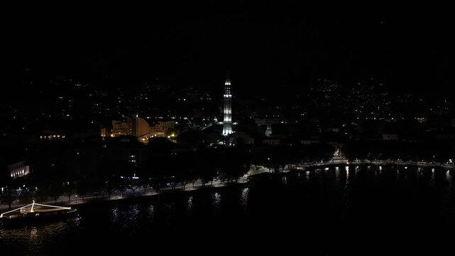 Nightlife tourism and travel aerial view of Malgrate cityscape with Lake Como waterfront at night