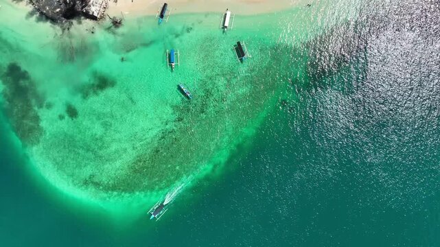 Top down aerial perspective of speechless beach in Gili Tangkong, crystal clear water in Lombok, Indonesia