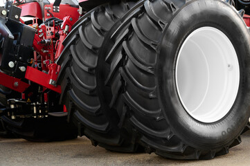 Close-up of the rear wheel of a large heavy farm tractor. © SKfoto GE