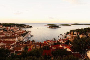 Naklejka premium Hvar town and Pakleni Islands viewed from the medieval Spanish Fortress, golden hour over the Adriatic sea, Croatia.