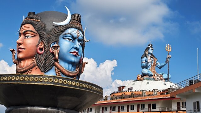 Dual-faced Lord Shiva and Goddess Parvati statue at Pumdikot Shiva Temple, Pokhara, Nepal, overlooking lush Himalayan hills under dramatic sky, captured October 2025. Iconic 