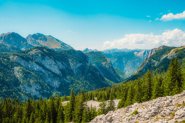 Fototapeta premium Alpine hiking trail from Prijevor in Bosnia to Trnovacko Lake in Montenegro, dramatic Dinaric Alps in Sutjeska park landscapes and crystal clear turquoise water.