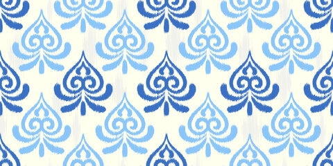 Ikat seamless pattern with abstract blue floral print. Textured traditional vector background for fabric. Oriental vintage rug decorative graphic. © Chorna_L