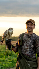 Naklejka premium Hunter with an eagle or hawk on his hand