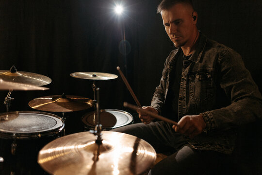 Drummer playing drums during rehearsal session.