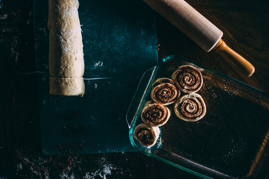 Cinnamon Rolls Getting Sliced and Placed