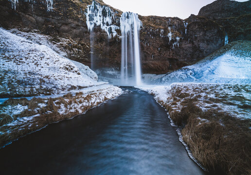 Seljalandsfoss waterfall in Iceland in frozon snow covered winter.