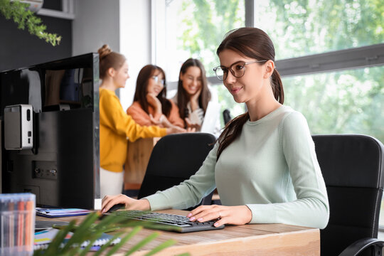 Female programmer working at table in office