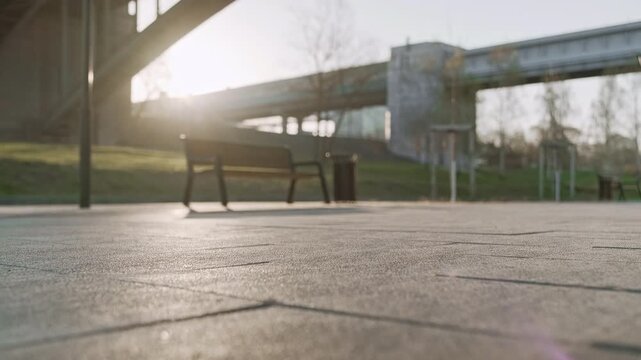Sportsman in athletic clothing fastening his running shoes beneath a bridge at sunrise. The image captures preparation for a morning run, emphasizing urban fitness, motivation, and active lifestyle.