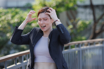 Fototapeta premium Stressed businesswoman experiencing frustration due to overwhelming problems