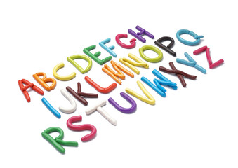 Fototapeta premium Abcdefghopqrstuvwxyz colorful clay alphabet letters arranged diagonally on white background with missing characters, creative education concept