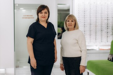 Fototapeta premium Optometrist and senior patient in eye care clinic