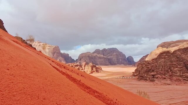 Man successfully sandboarding down steep red dune in Wadi rum showing skill balance confidence achievement and adventure Jordan