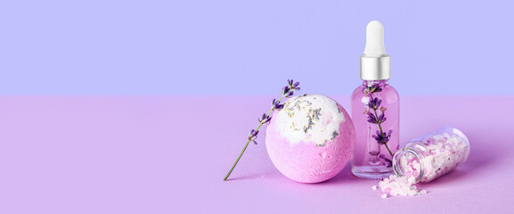 Lavender essential oil, bath bomb and sea salt on color background