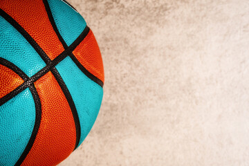 Vibrant orange and turquoise basketball with textured surface an