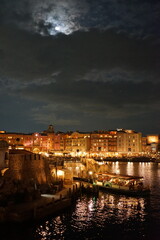 Fototapeta premium The photo captures a historic European harbor with boats gently docked along the water. The scenic view showcases charming architecture and peaceful waters, reflecting the rich maritime culture of the