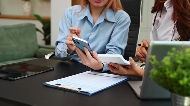 Businesswoman and team analyzing financial statement Finance task. with smart phone and laptop and  tablet. Wealth management