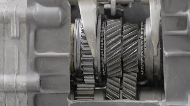 Close-up of a vehicle gearbox cutaway revealing gear train movement and transmission mechanism, ideal for engineering education, maintenance training, and technical demonstration