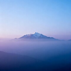 Mountain Peak with Snow Amidst Misty Landscape
