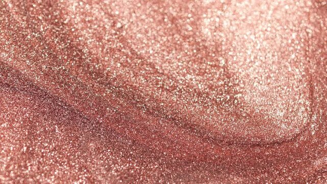 Detailed rotating close-up of dark golden paint with specialized sandy texture and radiant glitter particles sweeping on surface