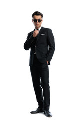 Obraz premium Confident man with hand in pocket adjusting tie