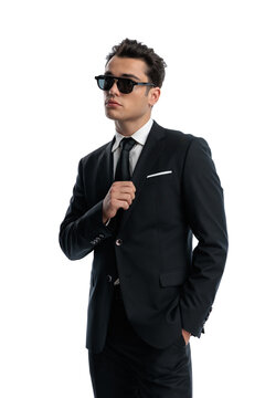 Confident man adjusting jacket and looking away
