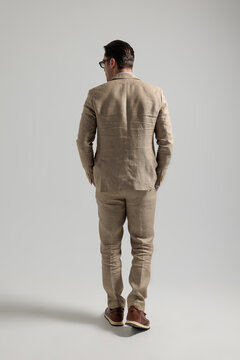 Back view of elegant man in suit walking away