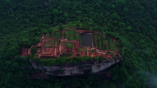 Cinematic aerial top-down of Sigiriya Lion Rock &ndash; Ancient fortress ruins and lush tropical jungle in the cultural triangle of Sri Lanka