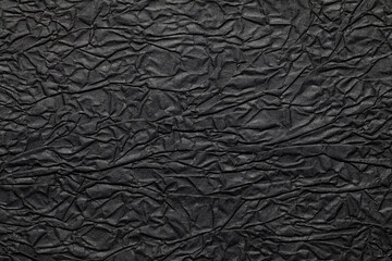 Close-up of wrinkled black paper texture background