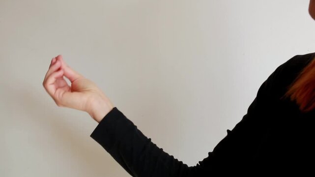 Woman making traditional Italian hand gesture symbolizing expressive communication, questioning or emphasis in conversation. Human body language concept.