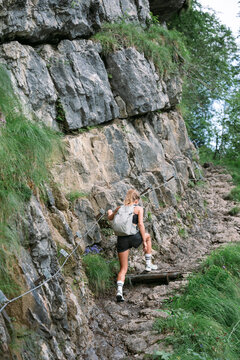 Woman with backpack hiking on mountain