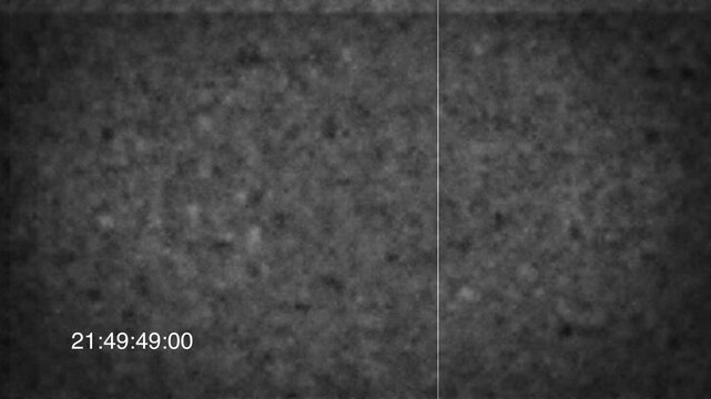 A 4K video of a textured gray concrete floor viewed from directly above at night with a timestamp overlay