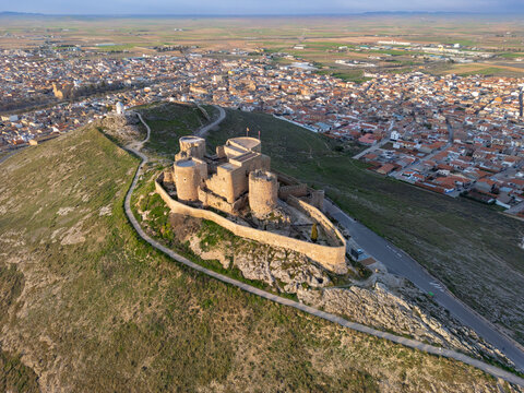 Aerial view of the Castillo de Consuegra standing proudly atop a hill, overlooking the surrounding town and plains, Consuegra, Castilla-La Mancha, Spain.