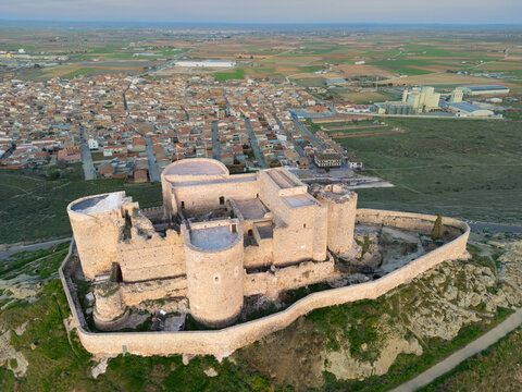 Aerial view of the imposing Consuegra Castle rises from the earth, a medieval fortress guarding the town with sturdy walls against a backdrop of distant fields, Consuegra, Castilla-La Mancha, Spain.
