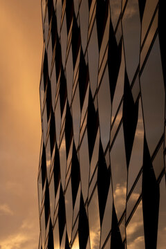 Dramatic abstract facade with shadow contrast and diagonal lines creating modern grid pattern across contemporary building exterior
