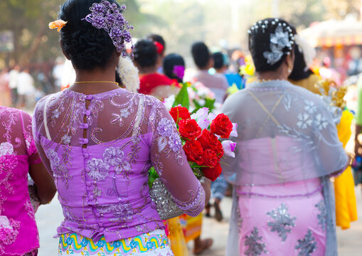 Women walking with offerings for a novitiation ceremony, Bagan,  Myanmar