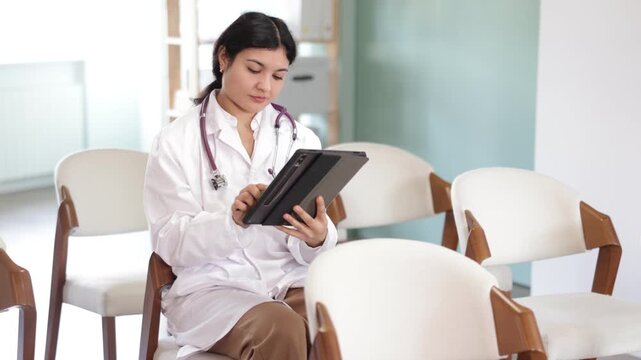 Female medical student point tablet camera at widescreen slide presentation screen, take photos, or scan QR ode to follow link. Photographing lecture educational material from screen 