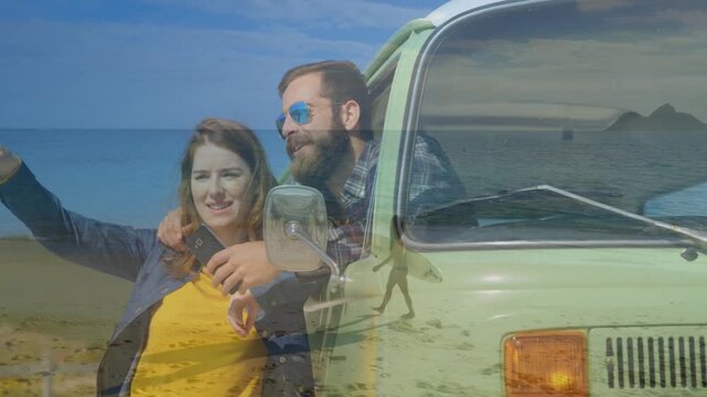Woman raising phone and pointing, starting crossfade silhouette walking over van hood for travel ad